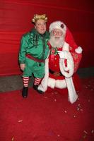 LOS ANGELES, NOV 28 - Michael Lee Gogin, as Christmas Elf Tom Connaghan, as Santa Claus arrives at the 2010 Hollywood Christmas Parade at Hollywood Boulevard on November 28, 2010 in Los Angeles, CA photo