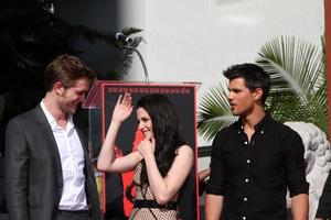 LOS ANGELES, NOV 3 - Robert Pattinson, Kristen Stewart, Taylor Lautner at the Handprint and Footprint Ceremony for the Twilight Saga Actors at Grauman s Chinese Theater on November 3, 2011 in Los Angeles, CA photo