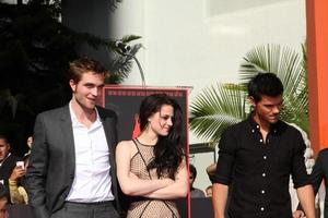 LOS ANGELES, NOV 3 - Robert Pattinson, Kristen Stewart, Taylor Lautner at the Handprint and Footprint Ceremony for the Twilight Saga Actors at Grauman s Chinese Theater on November 3, 2011 in Los Angeles, CA photo