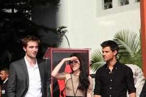 LOS ANGELES, NOV 3 - Robert Pattinson, Kristen Stewart, Taylor Lautner at the Handprint and Footprint Ceremony for the Twilight Saga Actors at Grauman s Chinese Theater on November 3, 2011 in Los Angeles, CA photo