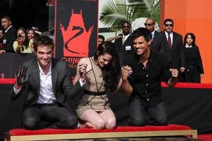 LOS ANGELES, NOV 3 - Robert Pattinson, Kristen Stewart, Taylor Lautner at the Handprint and Footprint Ceremony for the Twilight Saga Actors at Grauman s Chinese Theater on November 3, 2011 in Los Angeles, CA photo