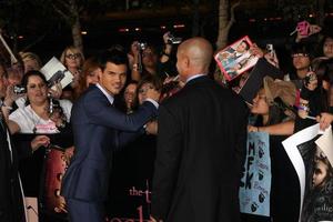 LOS ANGELES, NOV 14 - Taylor Lautner signing autographs at the Twilight - Breaking Dawn Part 1 World Premiere at Nokia Theater at LA LIve on November 14, 2011 in Los Angeles, CA photo