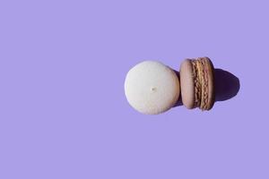 macarons on lavender background. Vanilla and chocolate macaroons. Delicate cakes on a lilac background. color of the year very peri photo