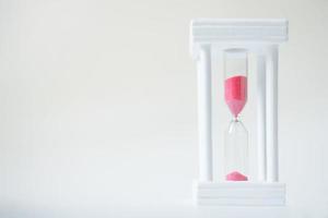 hourglass with red sand. Time is money. Leaks quickly. Outgoing opportunities. reading speed. hourglass on white background photo