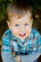 Sweet baby boy, closeup portrait of child isolated on wood background, cute toddler with blue eyes photo