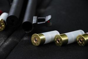 12 gauge red hunting cartridges for shotgun on wooden background.