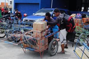 loading and unloading carts of passenger goods at the port of Bontang, East Kalimantan, Indonesia. november 09 2022 photo