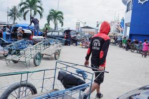 loading and unloading carts of passenger goods at the port of Bontang, East Kalimantan, Indonesia. november 09 2022 photo