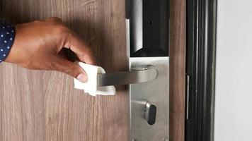 Wiping down door handle, sanitinz with tissue video