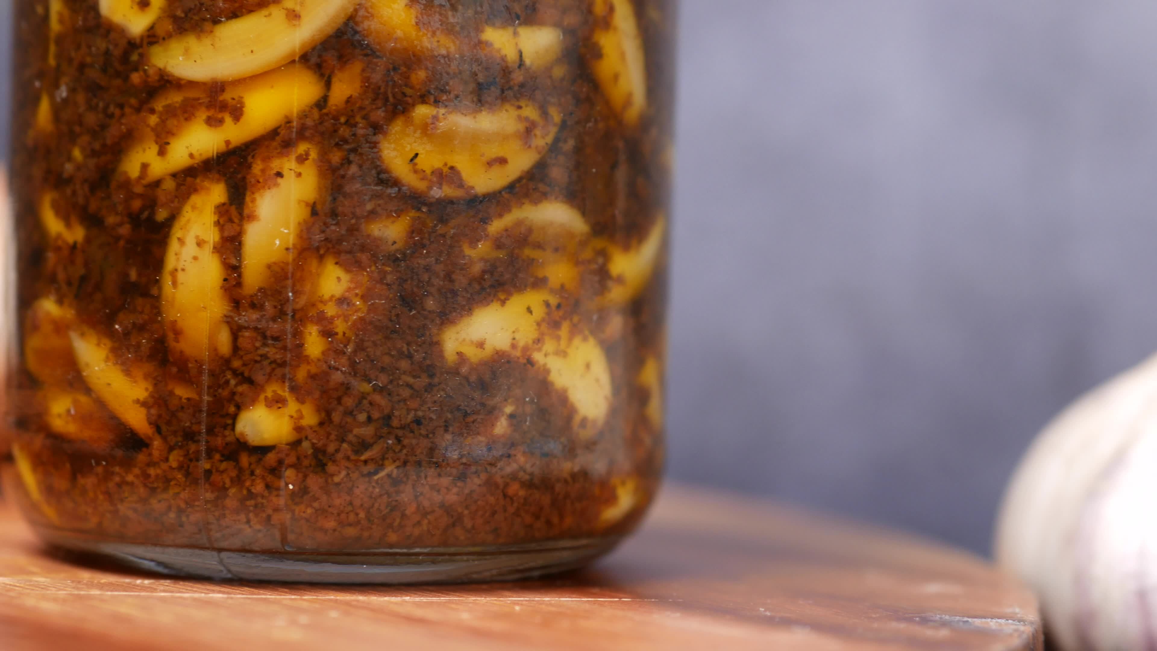 Peeled garlic in a jar with spices and oil 14142382 Stock Video at Vecteezy