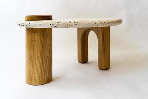 designer coffee table, solid wood base and top in terrazzo, oak wood on white background photo