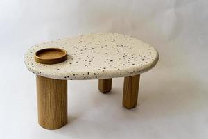designer coffee table, solid wood base and top in terrazzo, oak wood on white background photo