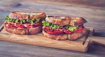 BLT sandwiches on the wooden board photo