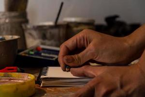 painting on blank canvas, hispanic woman with brushes and oil painting photo