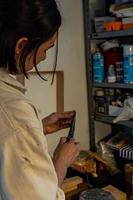 painting on blank canvas, hispanic woman with brushes and oil painting photo