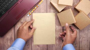 Man at work with piece of paper and little boxes video