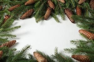 Holidays greeting card or banner composition with pine tree branches. Merry Christmas background and Happy New Year 2023. photo