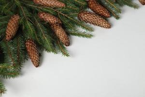 Holidays greeting card or banner composition with pine tree branches. Merry Christmas background and Happy New Year 2023. photo