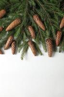 Holidays greeting card or banner composition with pine tree branches. Merry Christmas background and Happy New Year 2023. photo
