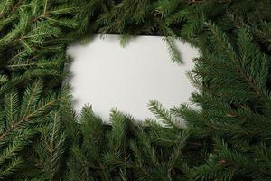 Holidays greeting card or banner composition with pine tree branches. Merry Christmas background and Happy New Year 2023. photo