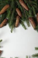 Holidays greeting card or banner composition with pine tree branches. Merry Christmas background and Happy New Year 2023. photo