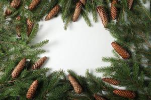 Holidays greeting card or banner composition with pine tree branches. Merry Christmas background and Happy New Year 2023. photo