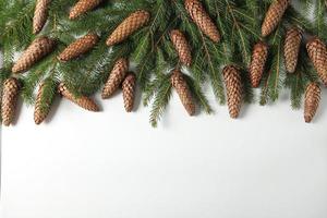 Holidays greeting card or banner composition with pine tree branches. Merry Christmas background and Happy New Year 2023. photo