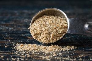 Ground Coriander Seeds Spilled from a Teaspoon photo