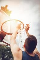 Installation Of Basketball Net On The Hoop photo