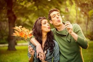 Couple Blowing Dandelion photo