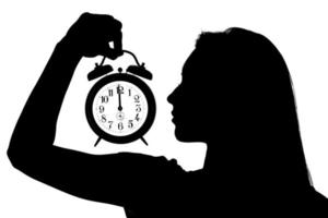 Woman Holding An Alarm Clock photo