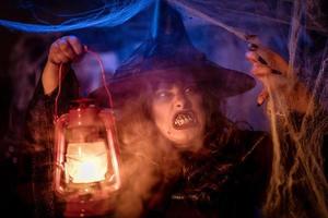 Witch With Lighted Lantern In Magic Fog photo