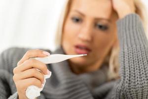 Worried Girl With Digital Thermometer photo