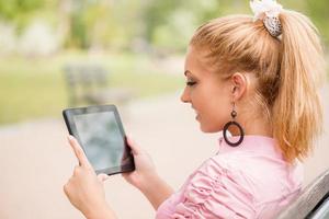 Woman Using Digital Tablet In The Park photo