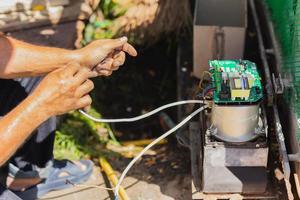 Technician man installing automatic electronic gate in the house. photo