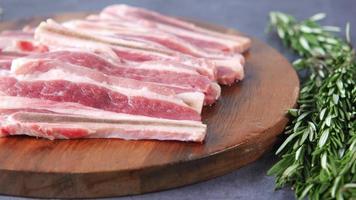 Raw thick sliced bacon on wooden platter video