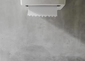 Toilet tissue box on loft grey wall with nature light and shadow background, copy space. photo