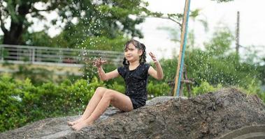 Childrens have fun playing mud slides in the community fields. photo