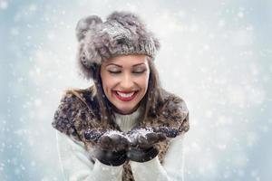 Cute Girl Blowing Snowflakes photo