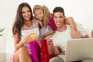 Happy family having online shopping photo