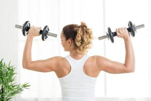 Woman Doing Exercises With Dumbbell photo