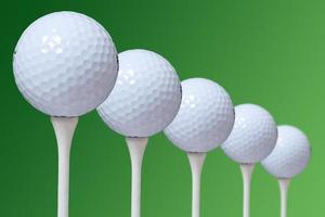 5 golf ball on green background photo