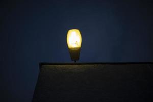 Lamp on roof of building. Light on house. Street lighting. photo