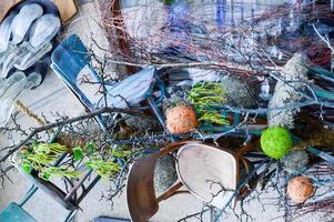 Abstract texture scattered in a chaotic random order of tree branches and wood stains with plants and wooden seats. The background photo