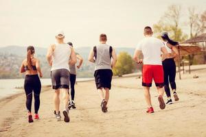 Group Friends Jogging On The Beach photo