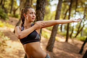 Girl Exercising In The Forest photo