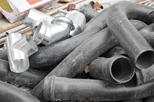 Large black plastic sewer plumbing pipes for the construction of water pipes or sewers at a construction site during the repair. Background, texture photo