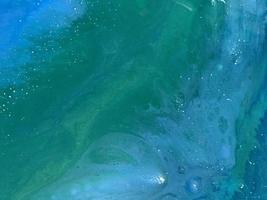 Abstract background of colored epoxy in marine theme. white bubbles on canvas made of wood. drawn wave by sea with potala and colored powders. Background to create pictures photo