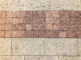 The brown texture of stone granite marble paving slabs. The background photo