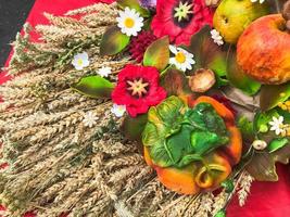 Wheat ears of dry straw of hay collected in a bouquet with seeds and stalks, leaves, fruits, flowers. The background. Texture photo